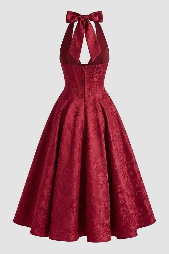 Back ghost mannequin view of the red floral jacquard wedding guest dress, detailing the flared midi skirt and open back cutout.