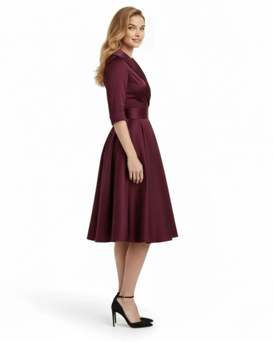 Woman wearing a burgundy dress on a white background