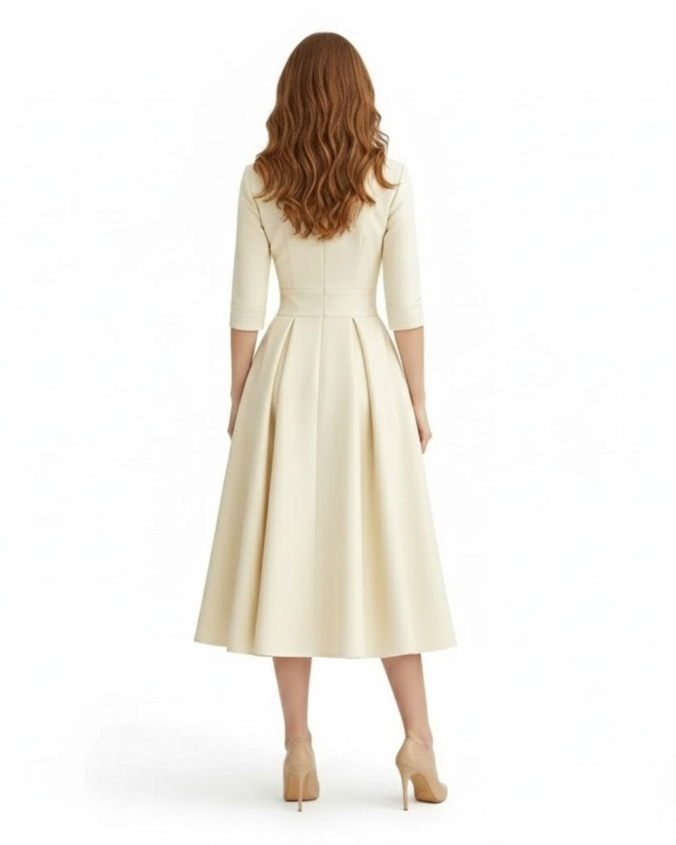 Woman wearing a cream-colored dress on a white background