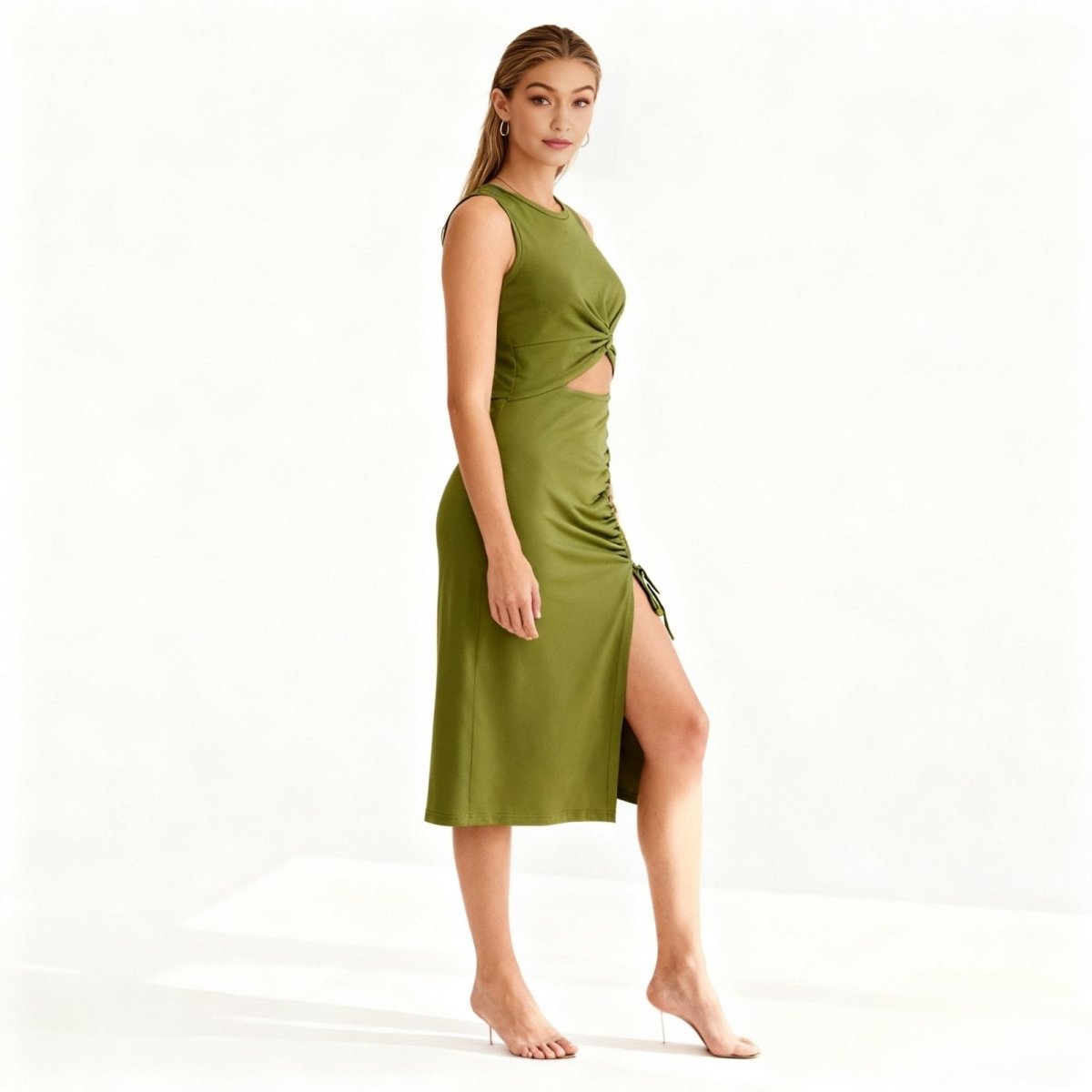 Woman wearing a green dress with a cutout design on a white background