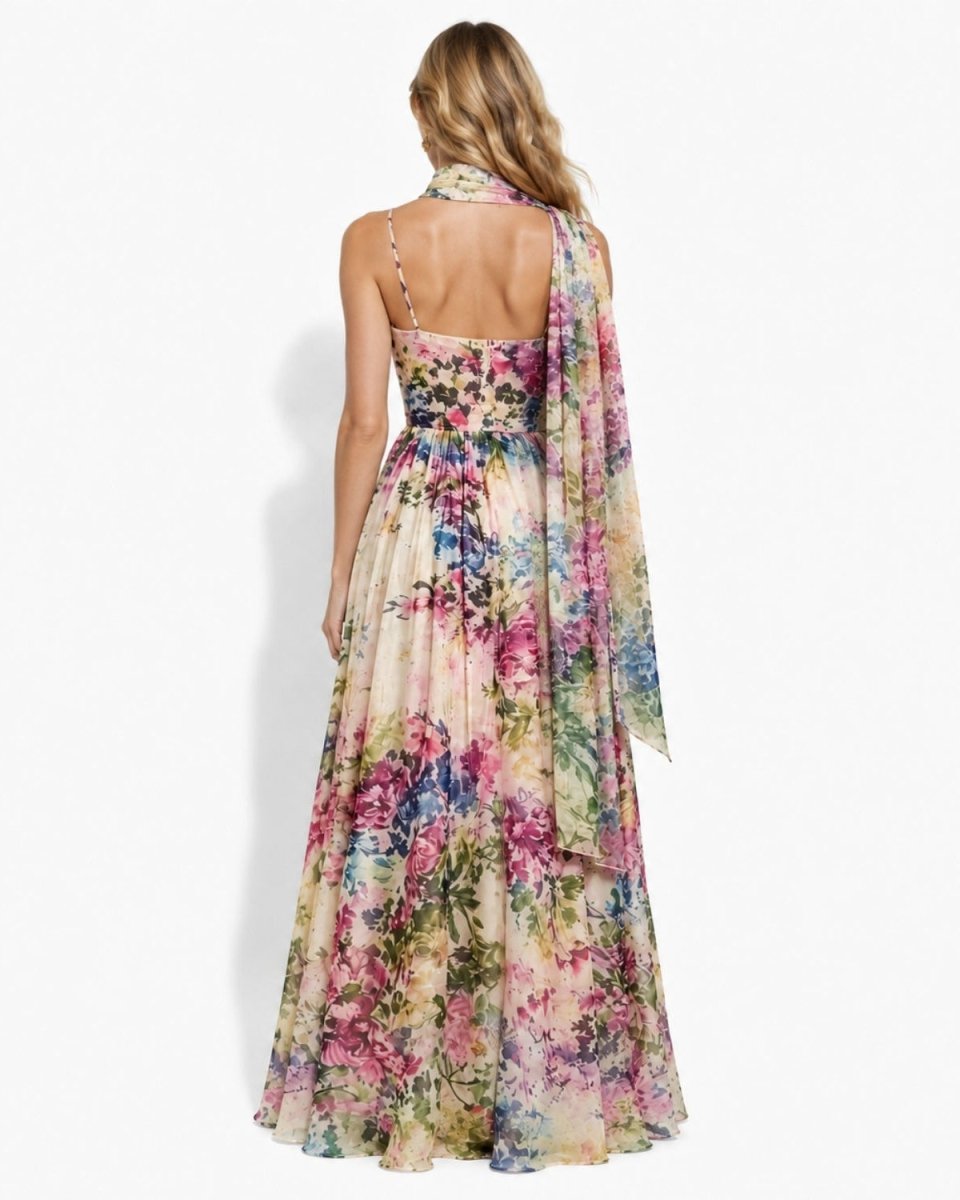 Full back view of the Ondara designer pastel floral wedding guest dress, detailing the hidden zipper closure, open back, and cascading chiffon scarf.