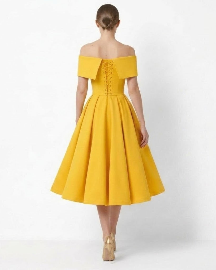 A woman viewed from the back wearing a bright yellow off-the-shoulder midi dress with a lace-up back and flared skirt, paired with beige heels, against a plain white studio background.