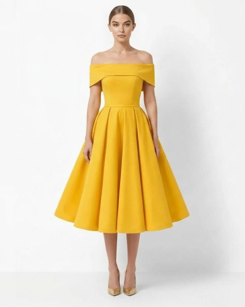 A woman modeling a bright yellow off-the-shoulder midi dress with a structured waist and flared skirt, paired with nude heels, against a plain white studio background.