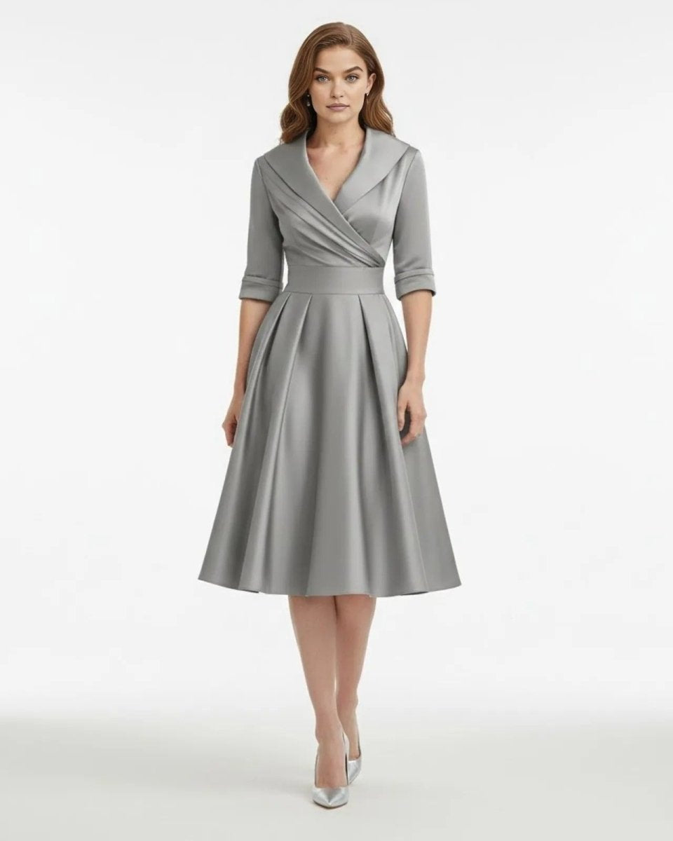 Woman wearing a gray dress on a white background