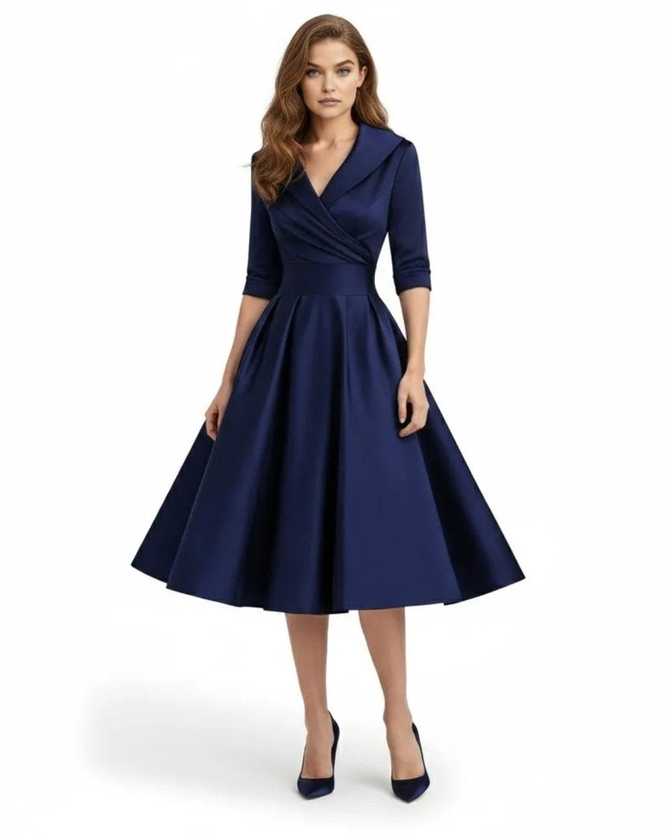 Woman wearing a navy blue dress on a white background