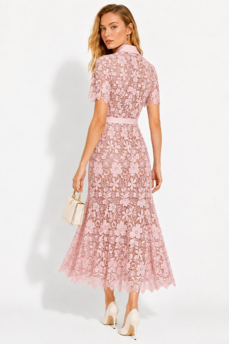 Back view of model wearing pink floral lace midi dress showing scalloped hem and fitted cut
