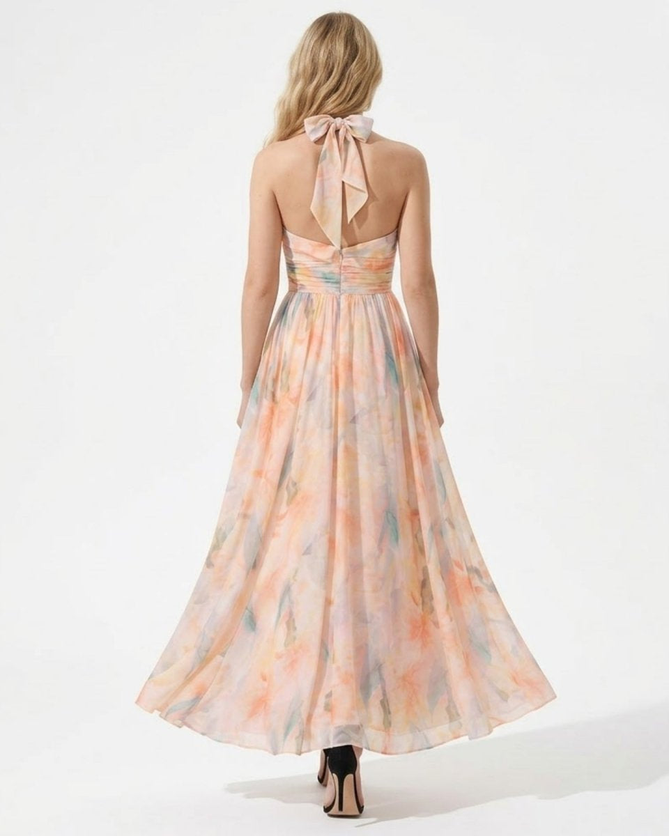 Back view of the Ondara floral maxi dress showing the adjustable halter bow tie and ruched waistline.