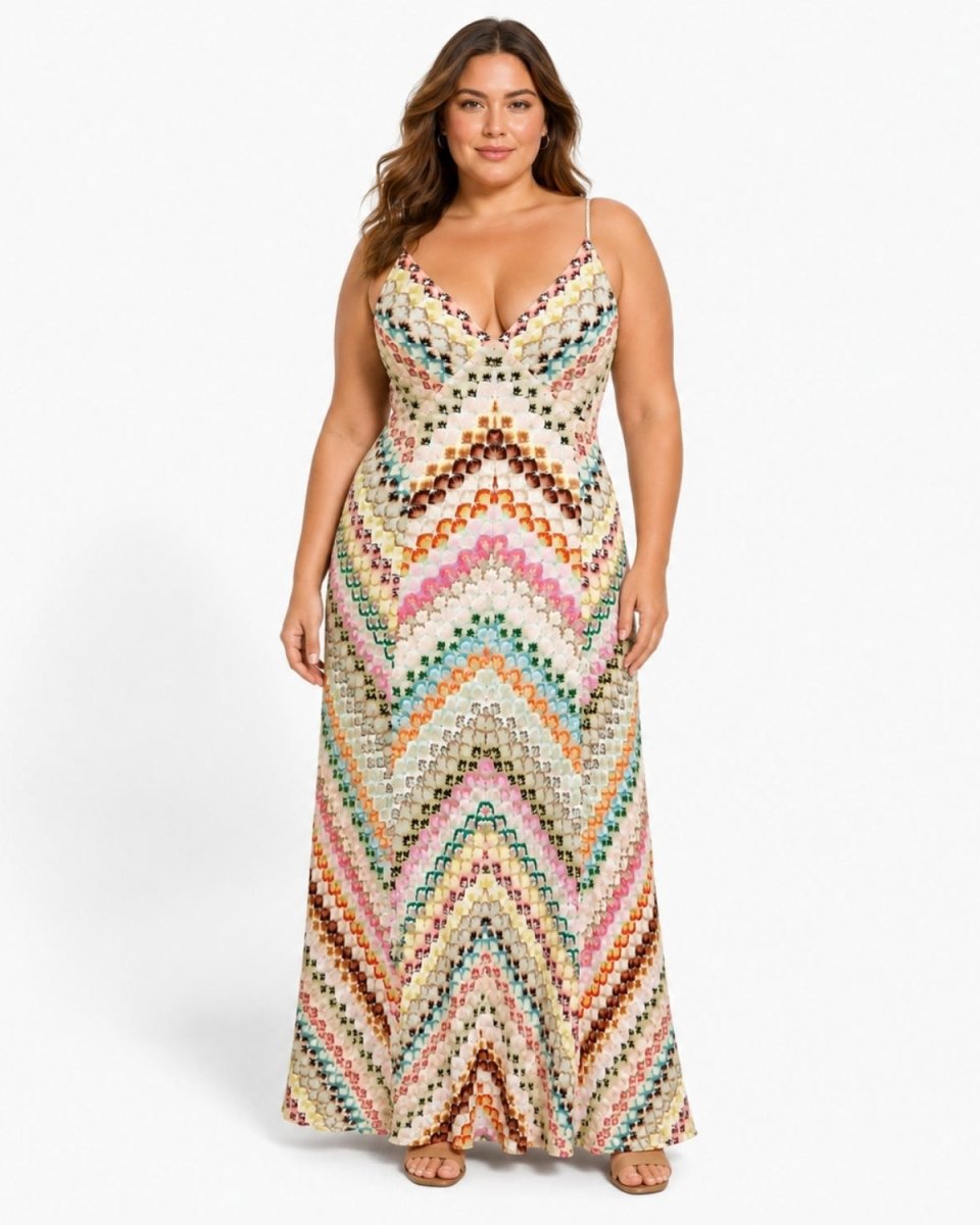 Plus size model showcasing the flattering fit of the Ondara pink multicolor chevron knit plunge maxi dress.