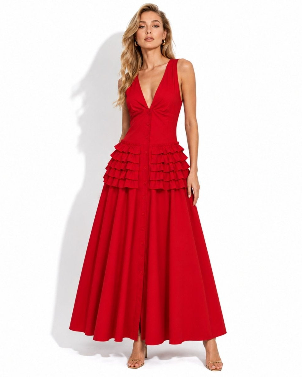 A woman modeling a sleeveless red maxi dress with a deep V-neckline, fitted bodice, and tiered ruffle detail at the waist on a white studio background.