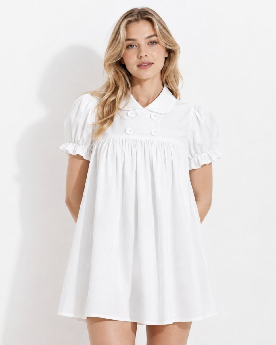 Woman wearing Ondara white puff sleeve babydoll mini dress with a vintage Peter Pan collar and double-breasted buttons, standing against a white background.