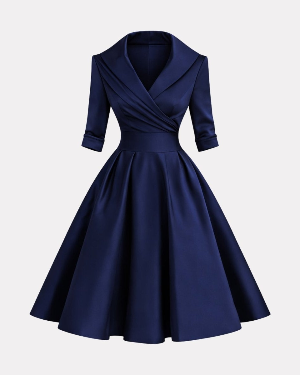 Navy blue dress with a draped bodice on a light gray background