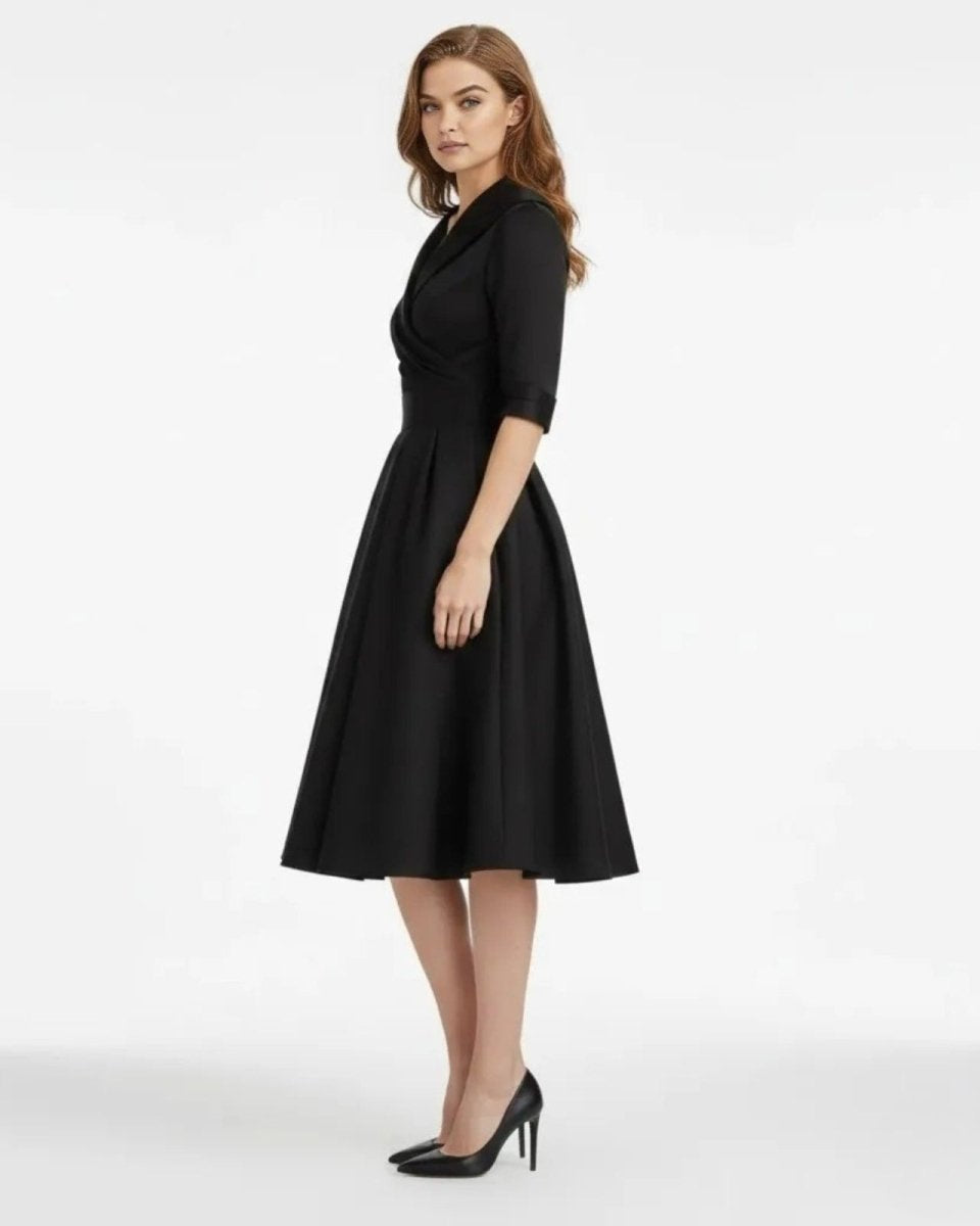 Woman wearing a black dress on a white background