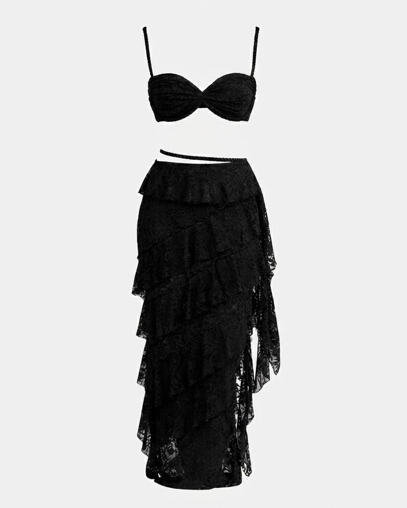 A two-piece black lingerie set featuring a ruched underwire bra top and a matching ruffled, tiered lace skirt, displayed on a solid light gray background.
