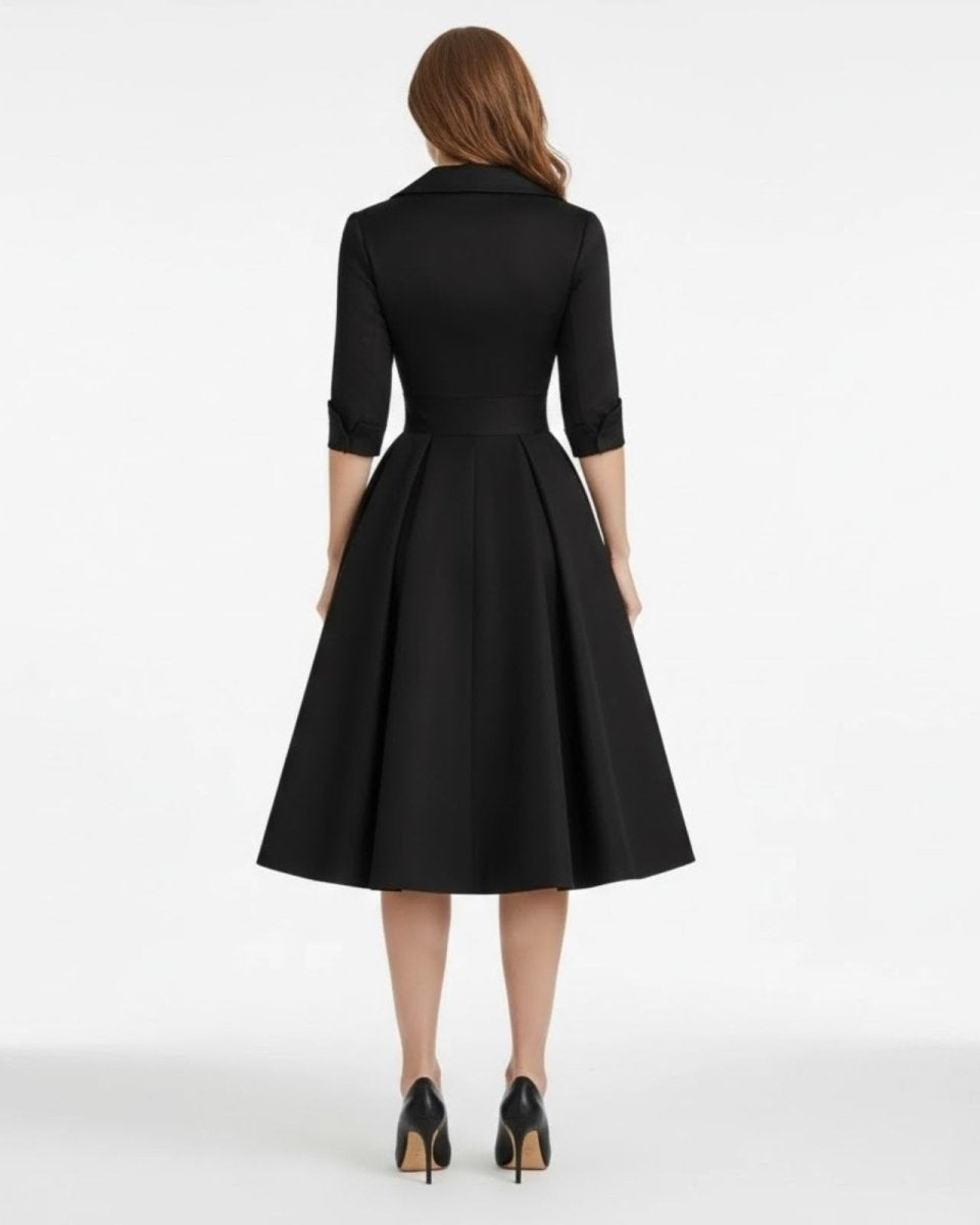 Black dress worn by a person on a white background