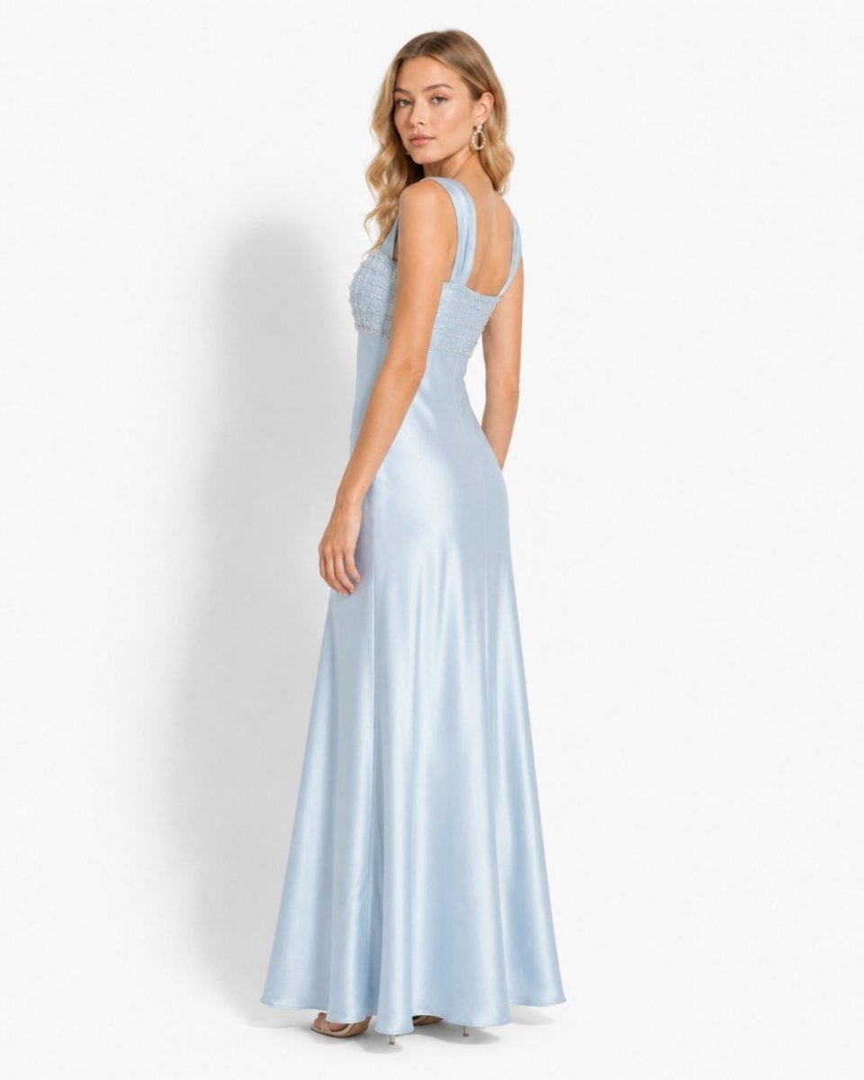 Side profile of the Ondara ice blue satin formal maxi dress, highlighting the fluid drape of the heavy satin fabric and the fitted empire waistline.