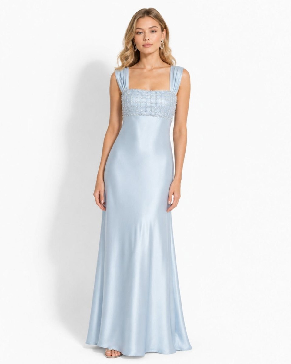 Front view of the Ondara ice blue satin evening gown featuring a square neckline with hand-beaded lattice detailing and a floor-length maxi skirt on a blonde model.