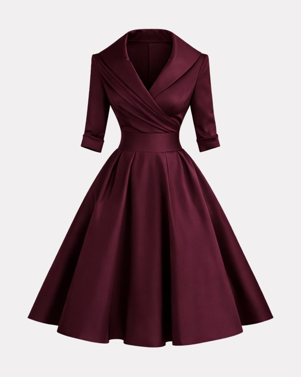 Maroon dress with a fitted bodice and full skirt on a light gray background