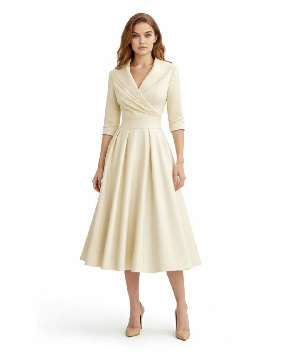 Woman wearing a cream-colored dress on a white background