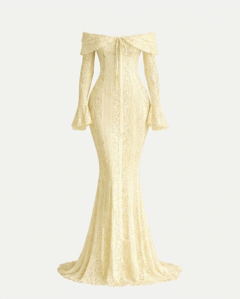 An off-the-shoulder, floor-length lace gown in a warm cream or pale yellow tone, shown on a plain light background. The dress features long flared sleeves, a fitted bodice, and a slight train.