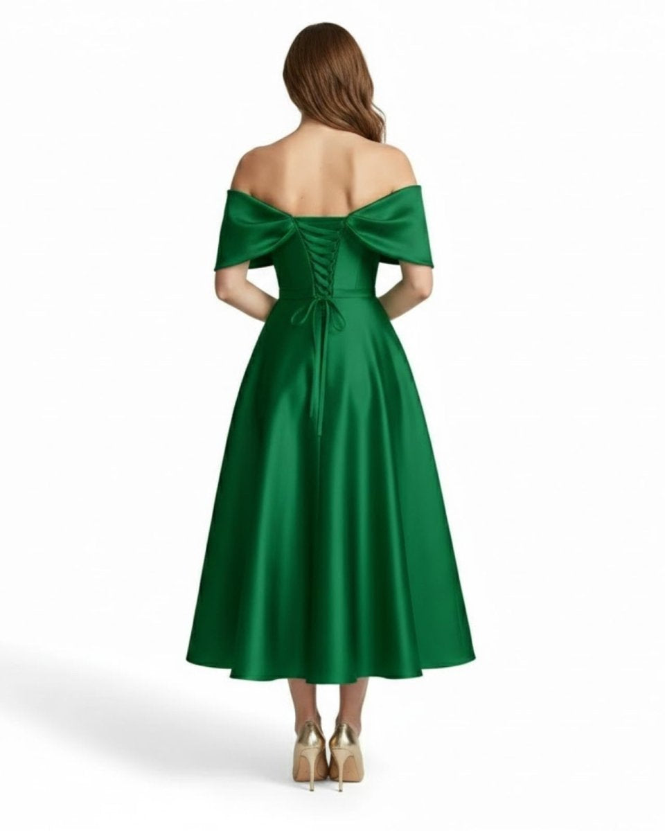 Back detail of green satin midi dress showing adjustable corset lace-up back and off-shoulder draping.