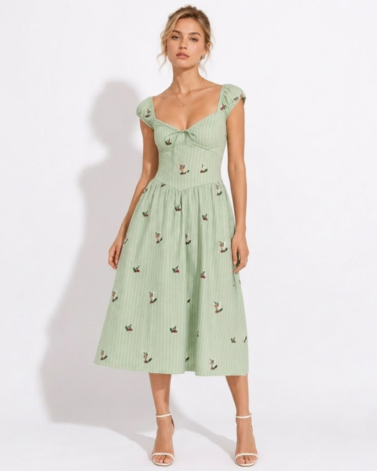 Front view of woman modeling Ondara green pinstripe floral embroidered corset midi dress with A-line skirt.