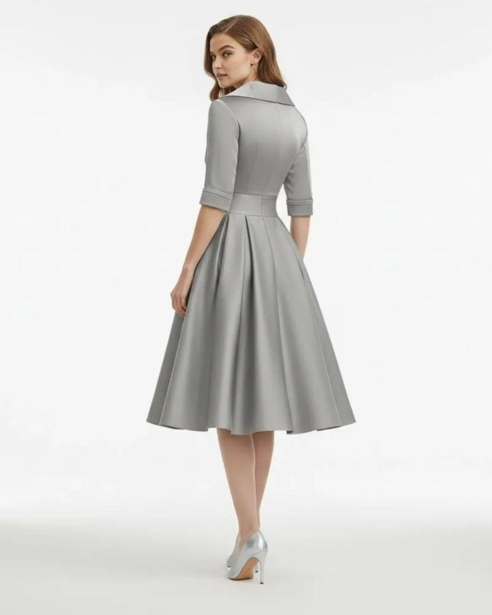 Woman wearing a gray dress on a white background