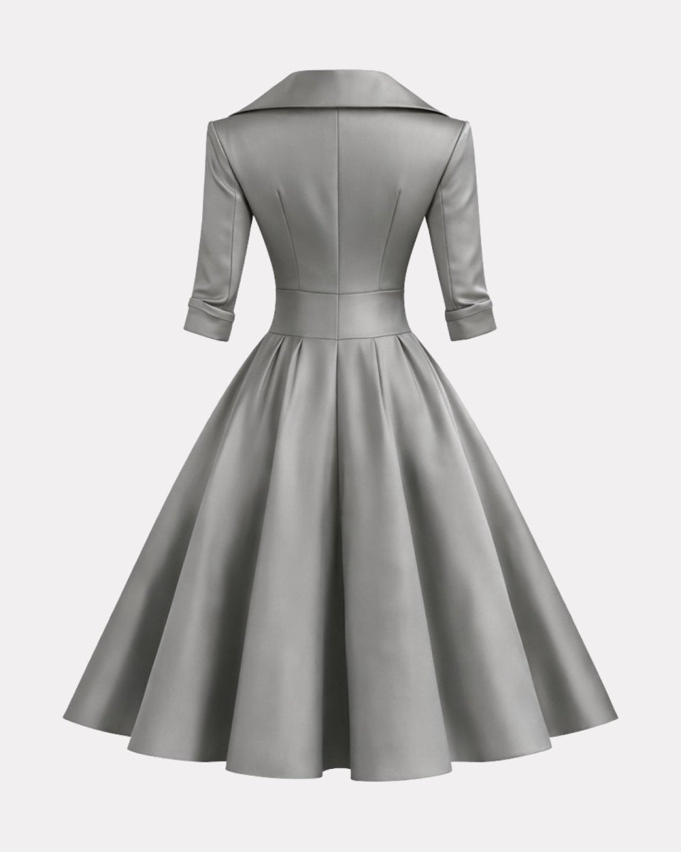 A light gray satin-like dress with a structured collar, three-quarter sleeves, a fitted waist, and a full flared skirt, shown from the back on a plain light gray background.