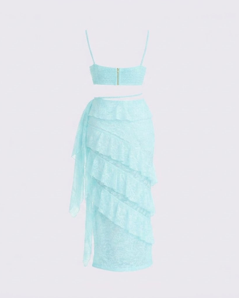 A light aqua blue two-piece set featuring a strapless bandeau crop top with a gold zipper at the center and a matching tiered ruffle skirt, displayed on a white mannequin against a light gray background.