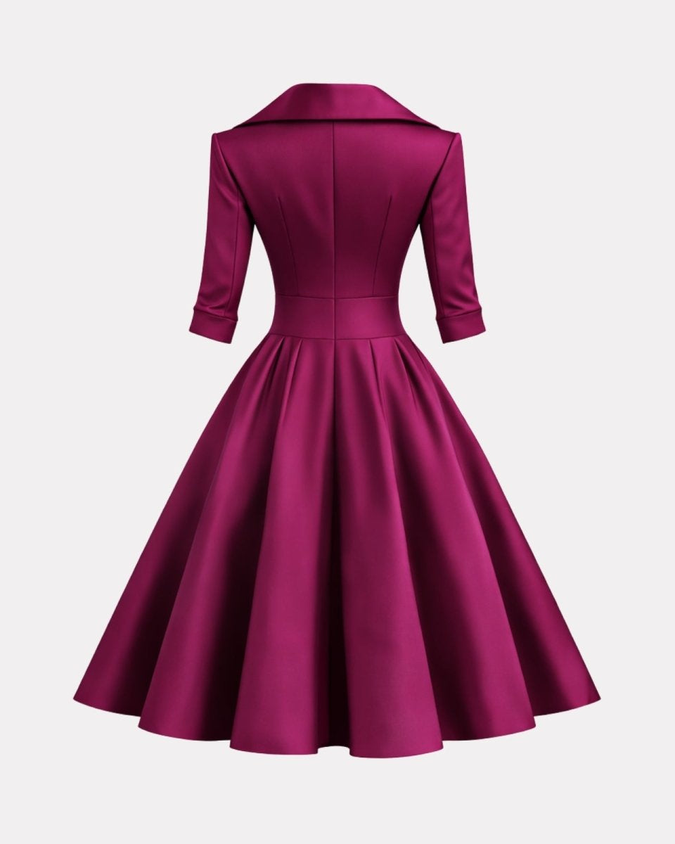 Magenta dress with a fitted bodice and full skirt on a light gray background