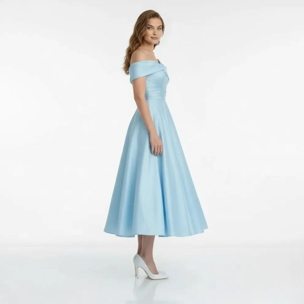Side profile of light blue satin A-line wedding guest dress with draped bodice.