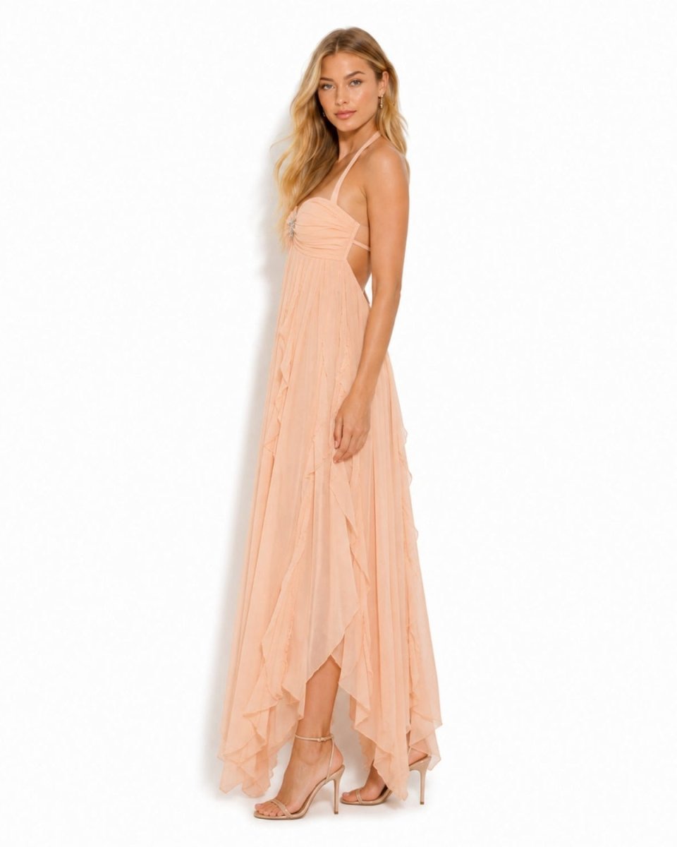 Side profile view of the Ondara peach luxury evening dress demonstrating the fluid movement of the ruffled skirt.