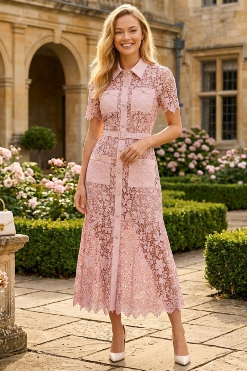 Woman wearing luxury pink floral lace shirt dress standing outside an elegant manor garden
