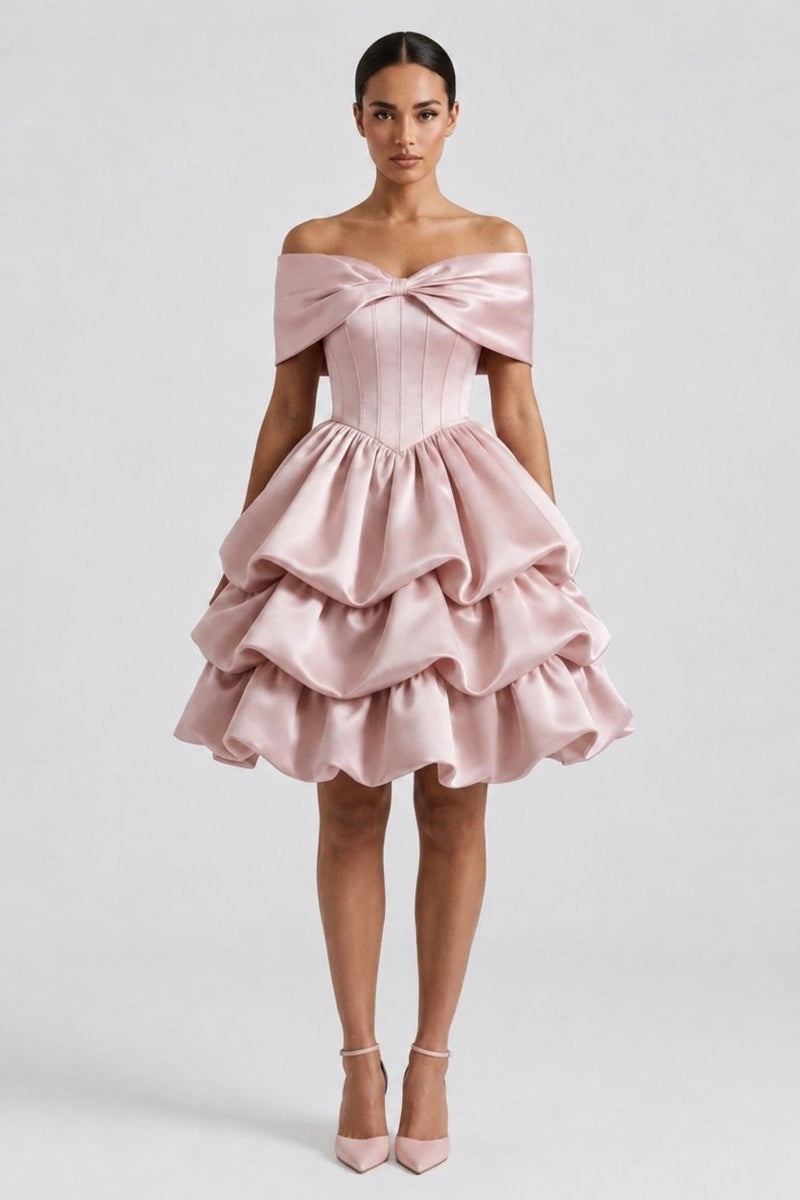 Model smiling in an opulent room with a chandelier wearing the Ondora Cosette luxury pink satin off the shoulder corset party dress.