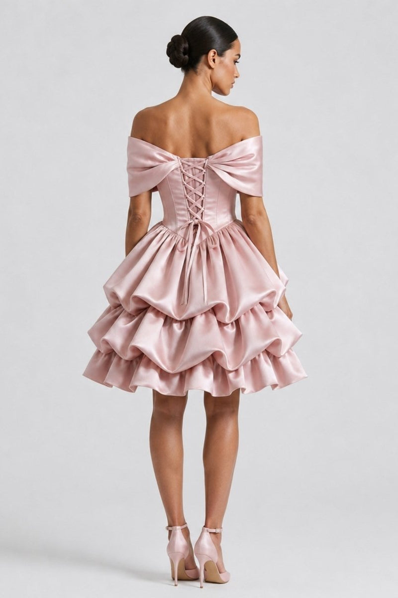 Back profile of a model showcasing the adjustable lace-up back corset and off-the-shoulder wrap on the Ondora Cosette pink satin dress.
