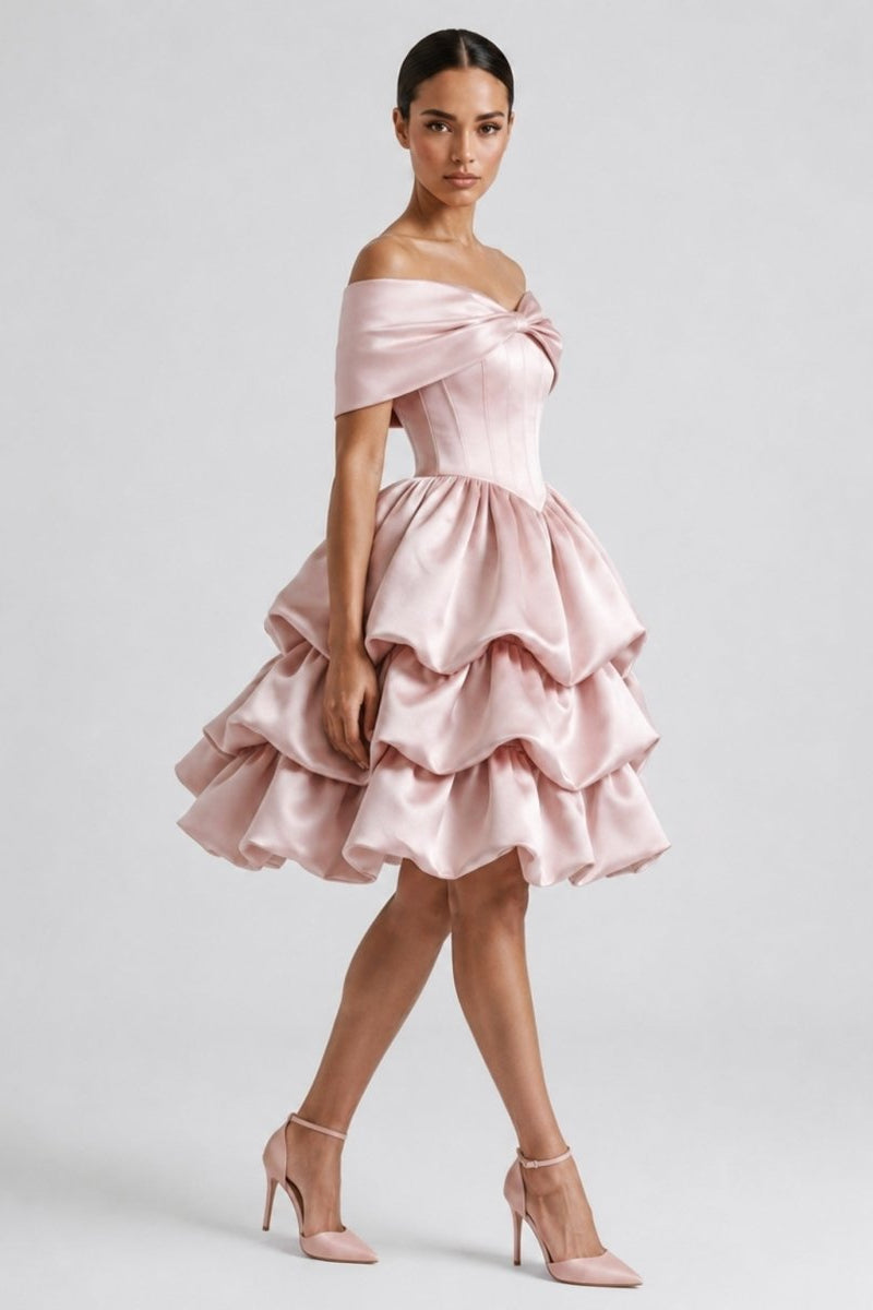 Side profile of a model wearing the Ondora Cosette pink satin corset dress highlighting the voluminous tiered bubble skirt silhouette.