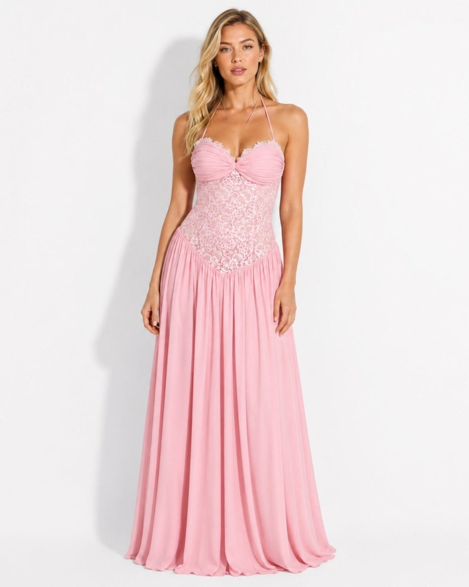  Pastel pink lace corset basque waist maxi dress by Ondara, featuring a ruched sweetheart neckline, delicate lace bustier, and flowing pleated chiffon skirt modeled by a woman on a white background.