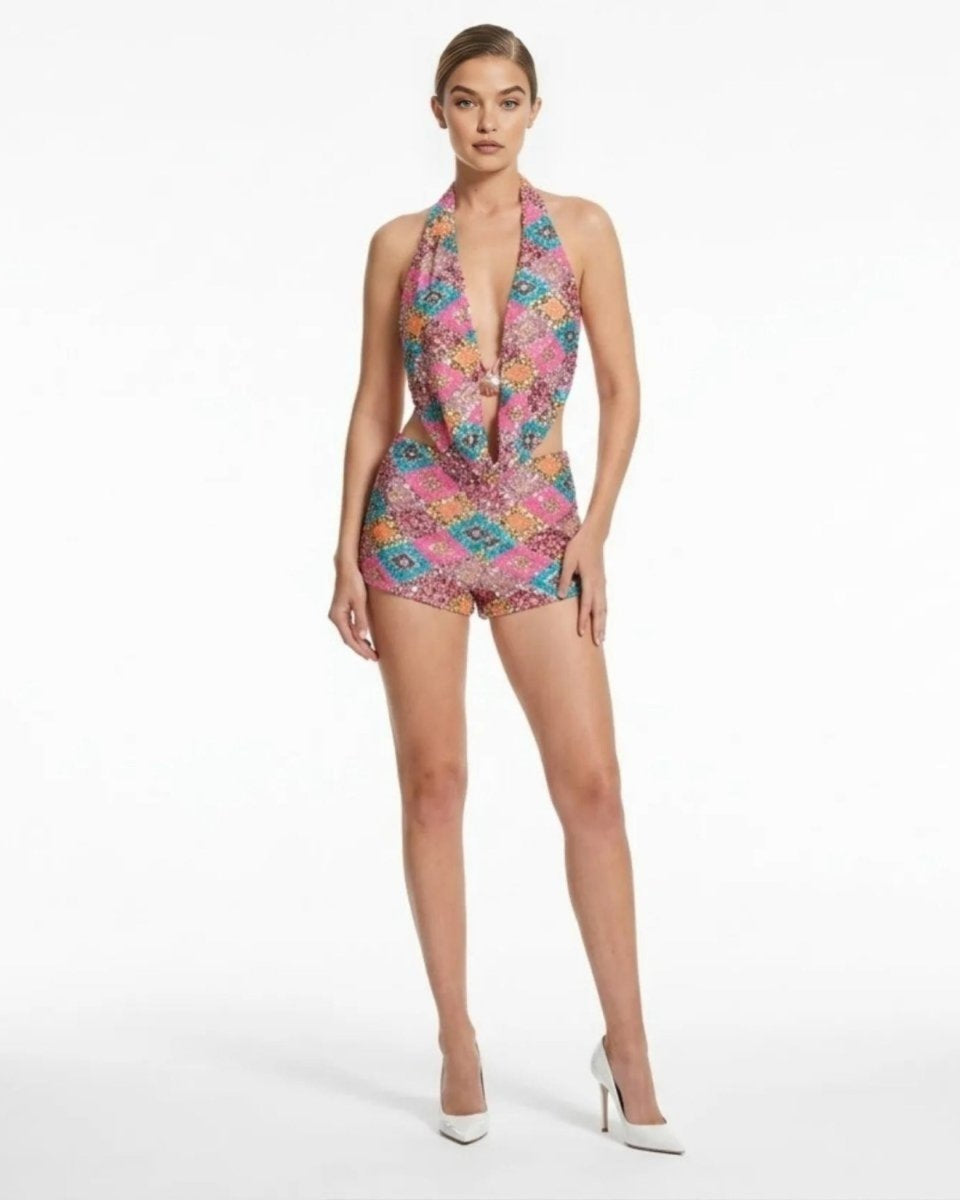 Woman wearing a colorful patterned romper on a white background