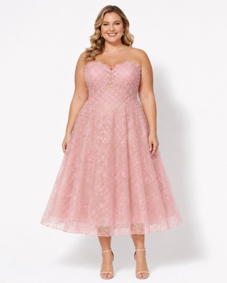 Plus size model elegantly wearing the Ondara pink strapless lace midi dress with a sweetheart neckline.
