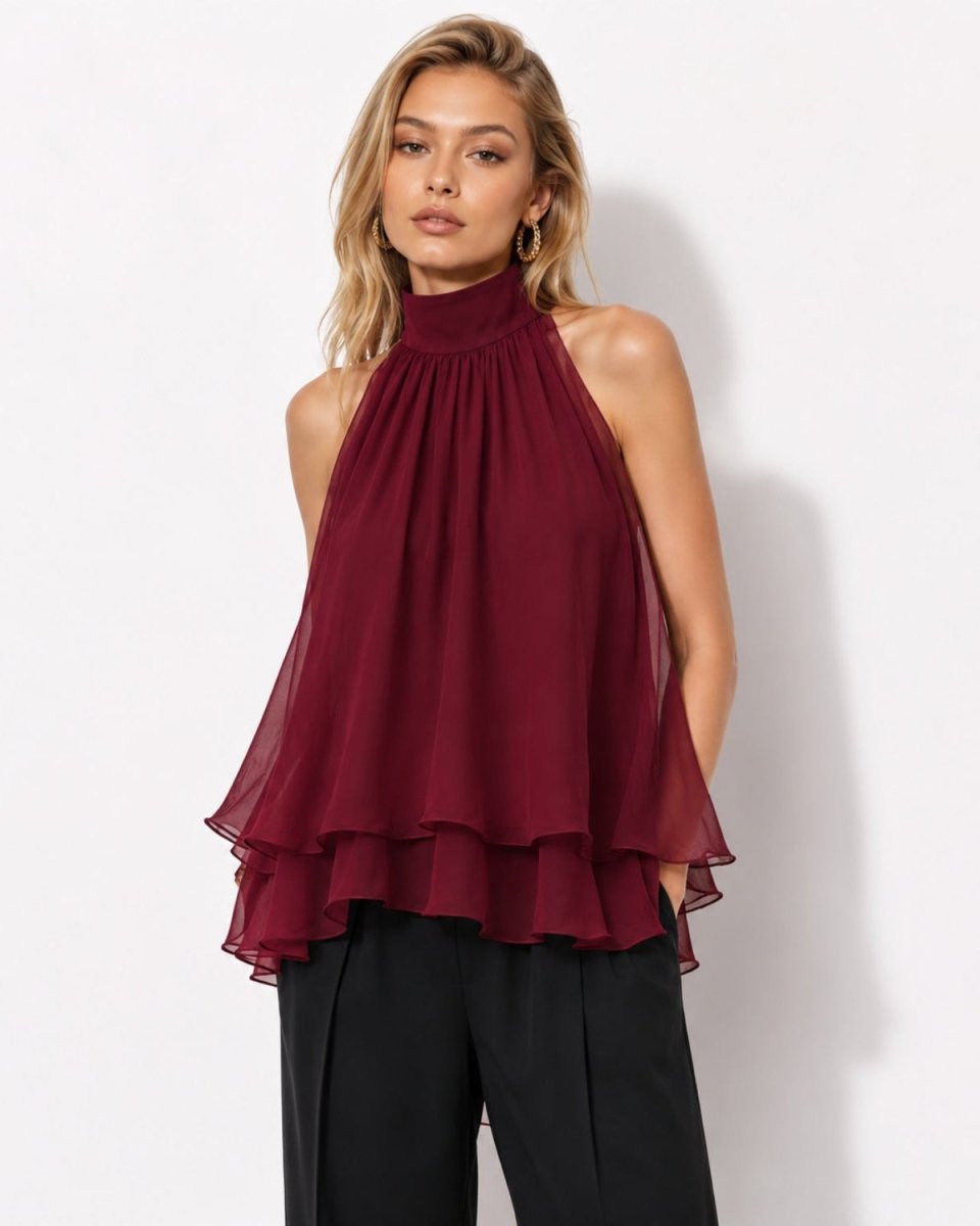 Front view of model wearing the Ondara tiered chiffon halter blouse in deep burgundy, featuring a high neckline and flowy ruffle evening top silhouette.