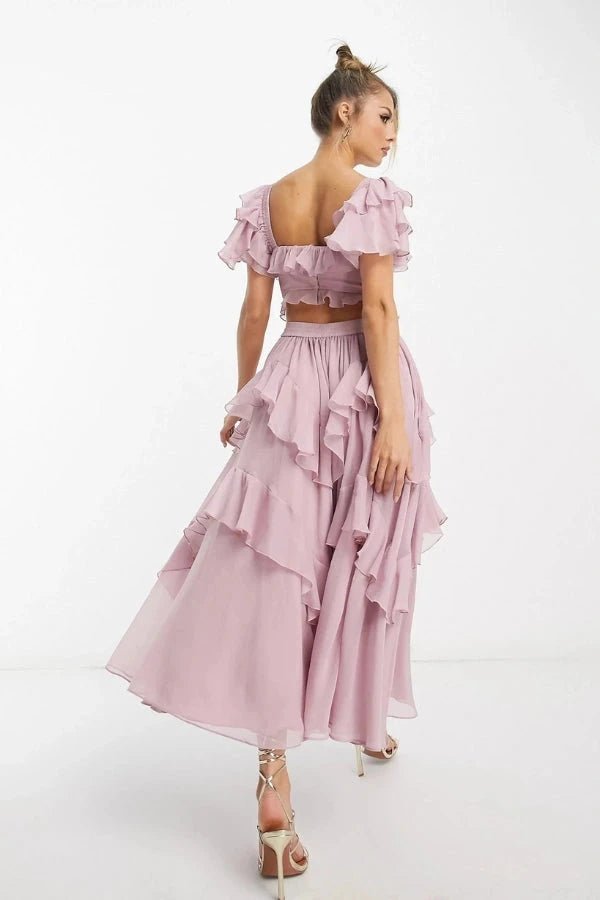 Back view of luxury dusty pink two piece wedding guest dress showing back cutout and ruffled sleeves