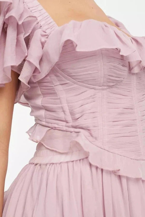 Close up detail of the hand-pleated corset bodice and structural boning on the dusty pink ruffle top