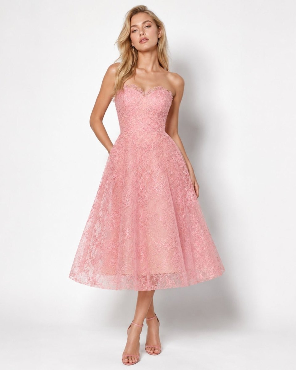 Woman modeling the Ondara pink strapless sweetheart cocktail dress with an A-line lace midi skirt.