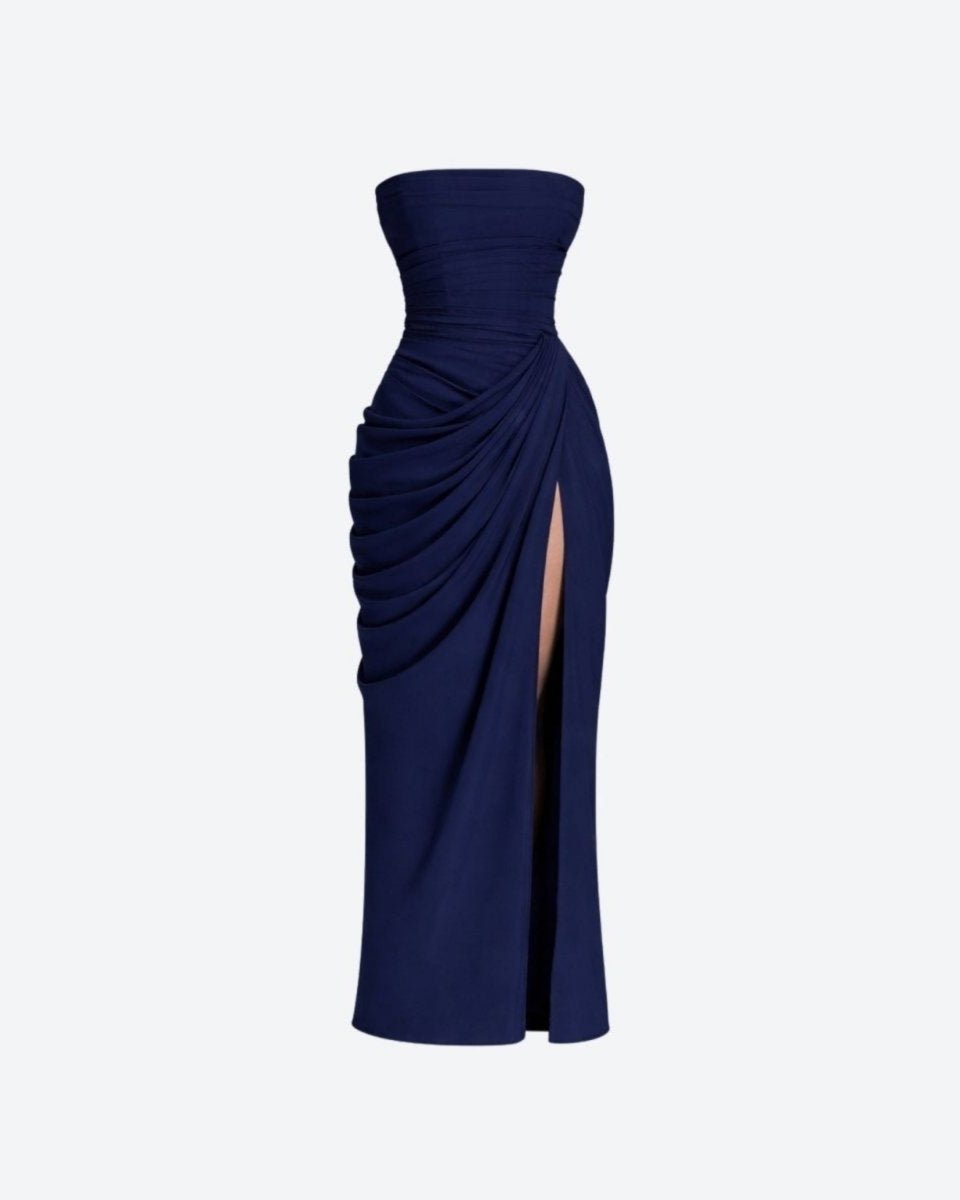 A strapless navy blue maxi dress with a ruched draped bodice and a high thigh slit, shown against a plain light gray background.