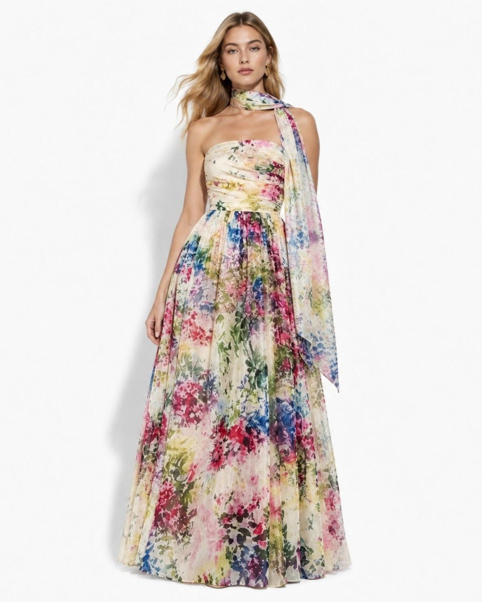 Front view of the Ondara luxury watercolor floral chiffon maxi dress, featuring a strapless ruched bodice, flowing skirt, and matching neck scarf on a blonde model.