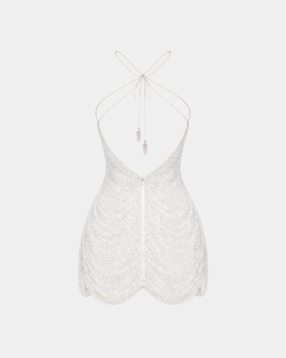 A white textured halter top with a deep V-neckline, thin adjustable tie-back straps, and a scalloped hem, shown against a light gray background.