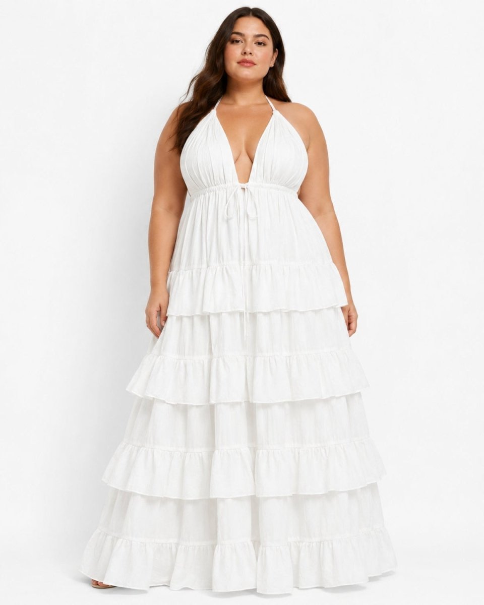 Plus size model wearing white deep V-neck tiered halter maxi dress