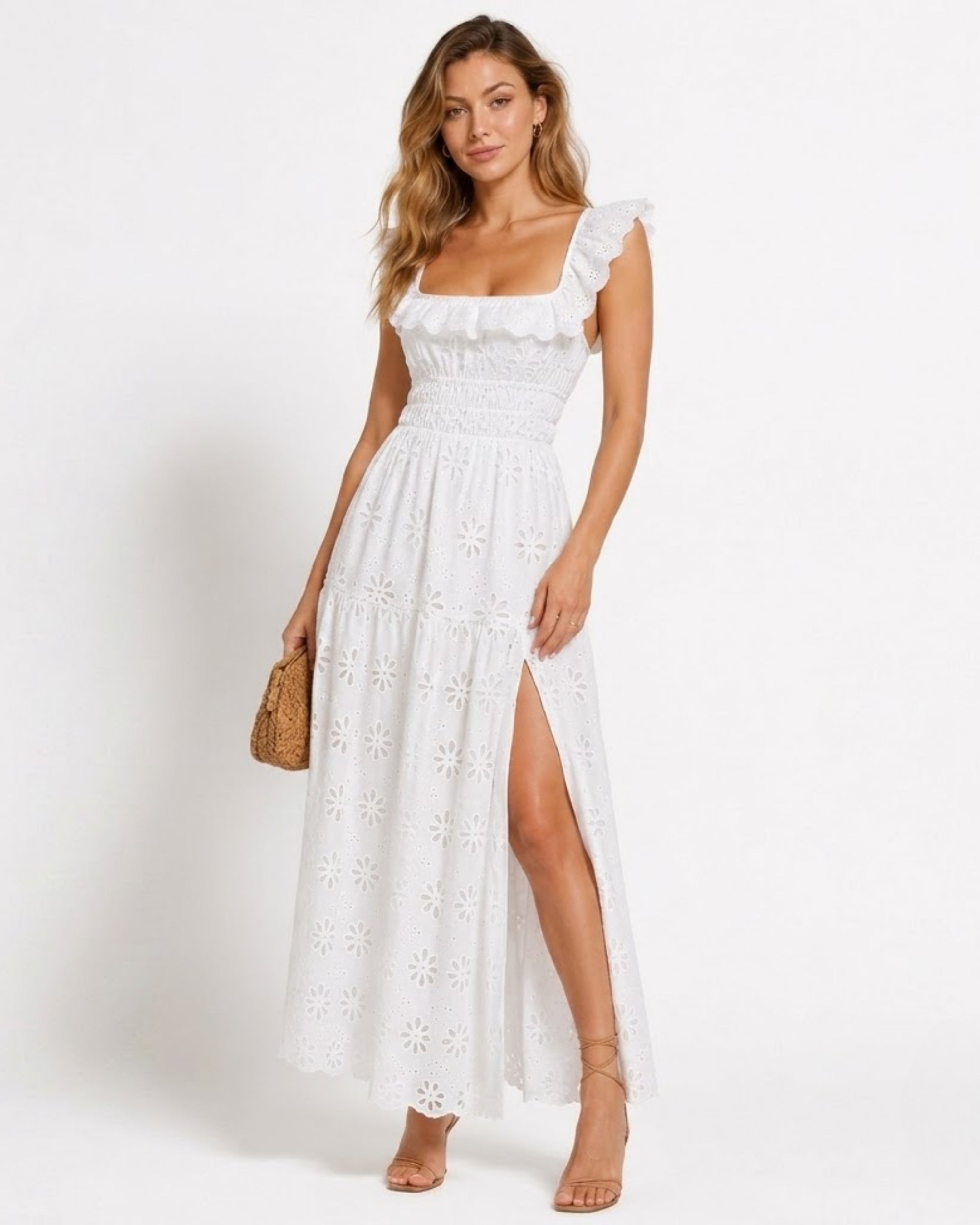 Front view of the Ondara luxury white eyelet lace maxi dress featuring a smocked waist, ruffle square neckline, and a high thigh slit.