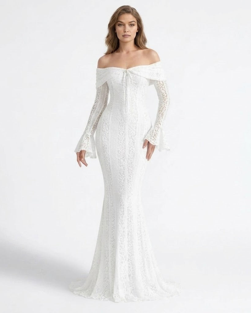 A woman modeling an off-the-shoulder white lace mermaid gown with long bell sleeves and a fitted silhouette, photographed against a clean white studio background.