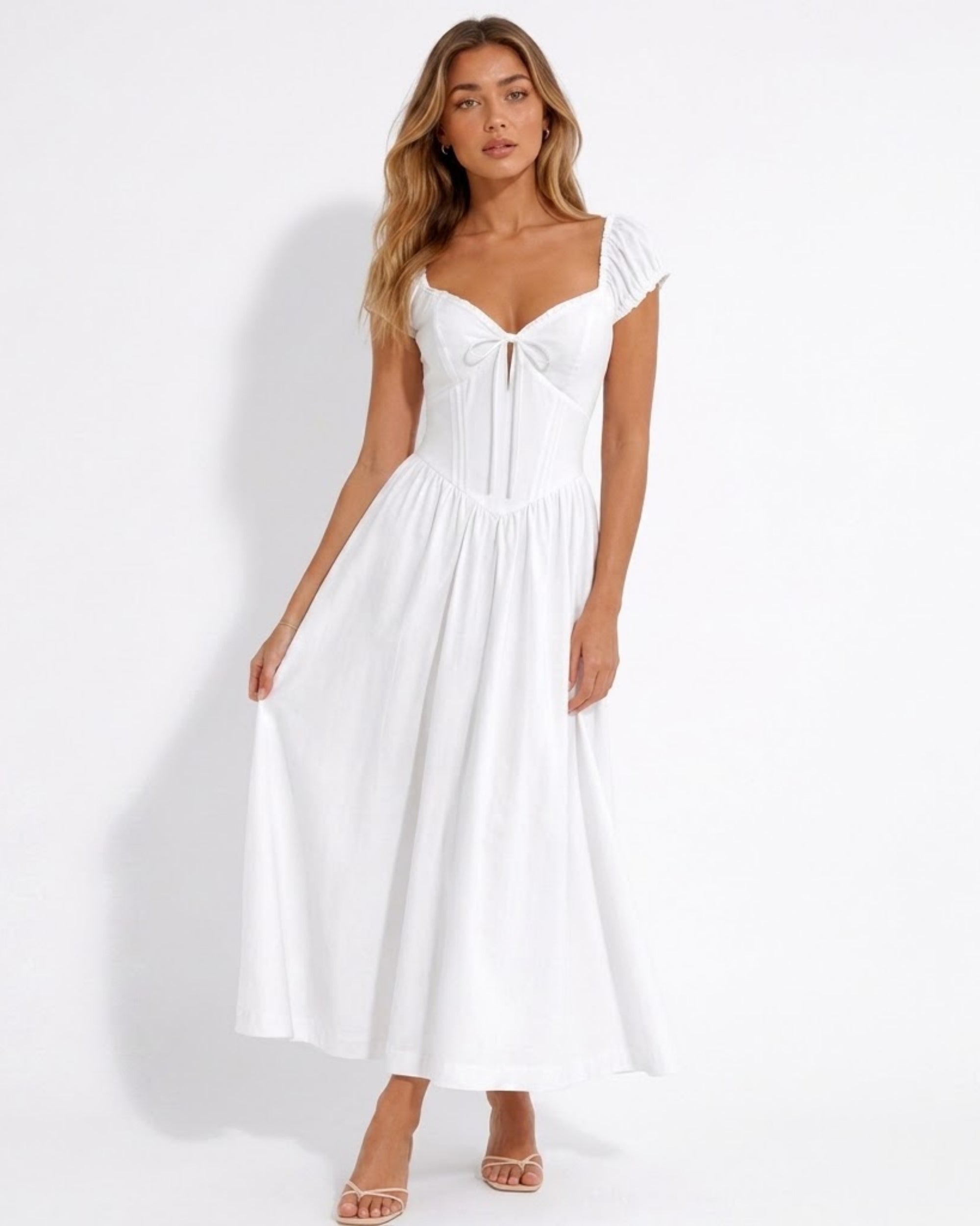 Front view of woman wearing Ondara white pinstripe floral embroidered corset midi dress with puff sleeves and tie-front bodice.