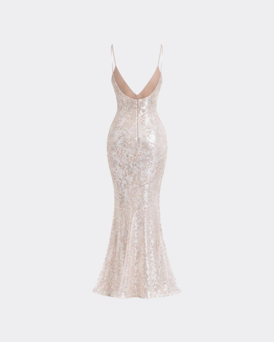A floor-length champagne sequin gown with spaghetti straps and a plunging V-neckline, shown against a light gray background.